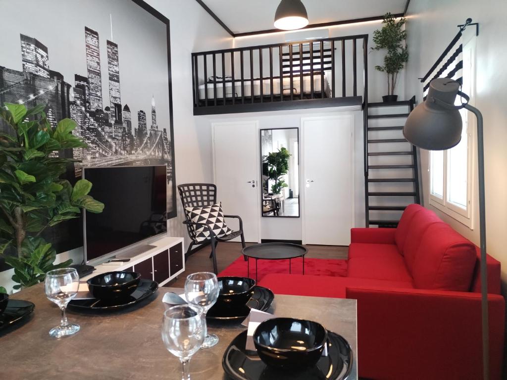 a living room with a red couch and a tv at Pihapiilo in Raahe