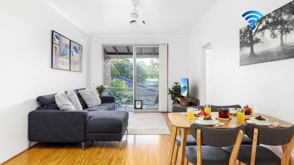 a living room with a couch and a table at Beachside at Gretel in Nelson Bay
