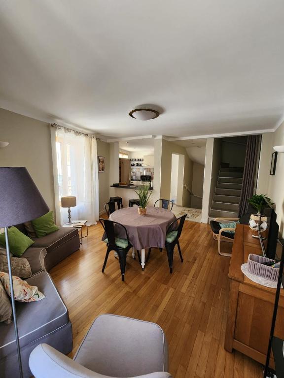 a living room with a table and a couch at La Tour Cicon in Salins-les-Bains