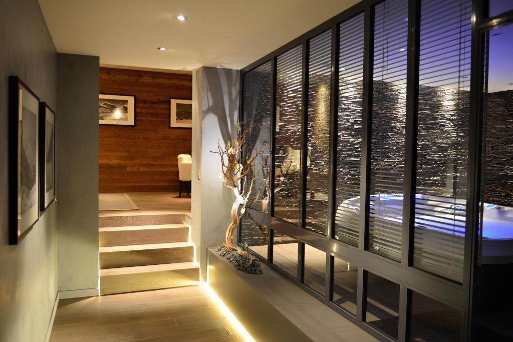 a staircase leading to a bathroom with a view of the city at L'Orchidée in Sévrier