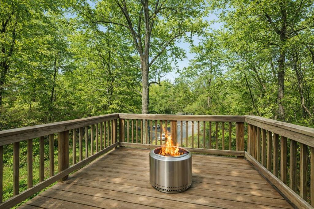 a fire pit sitting on a wooden deck at Litorum - a place to land, breathe, and reset in Front Royal