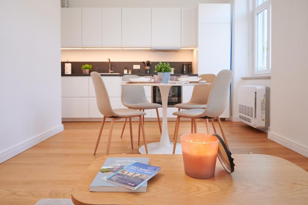 a kitchen and dining room with a table and chairs at TORTORELLA Apartments in Gorizia