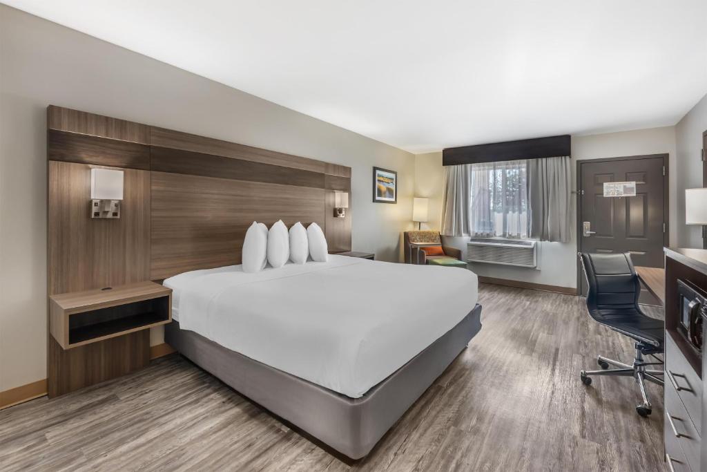 a hotel room with a large bed and a desk at Best Western Dos Rios in Junction