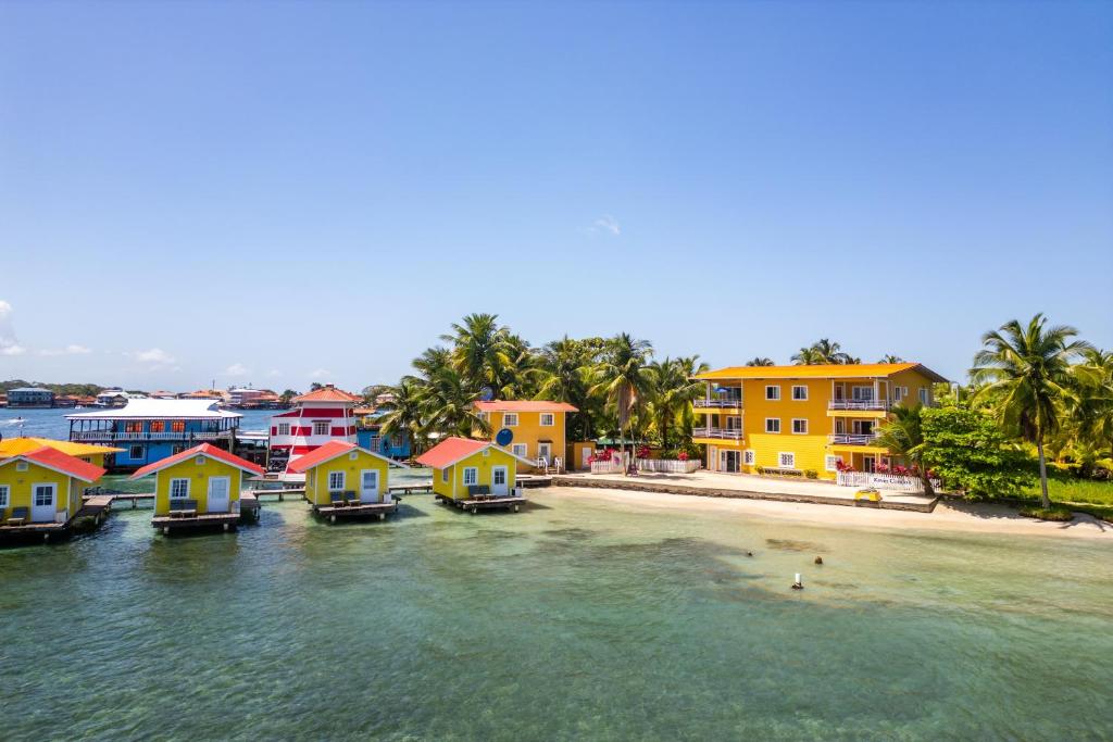 a group of houses on the water next to a beach at Faro del Colibri in Bocas Town