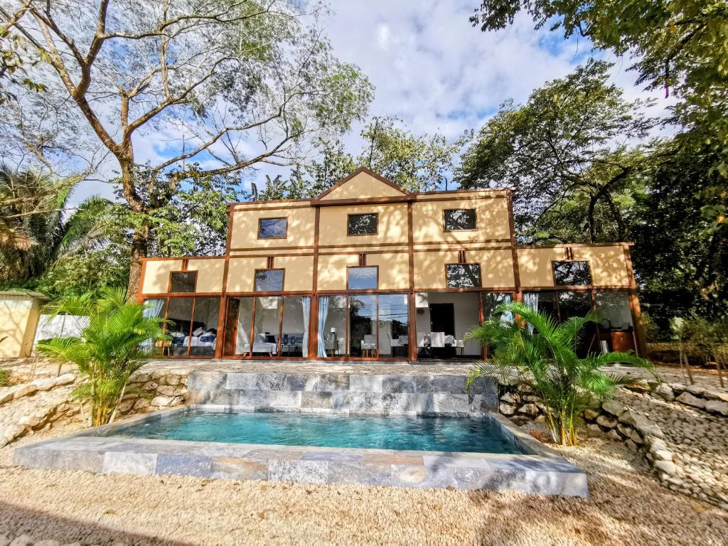 an exterior view of a house with a swimming pool at Villa Palladio Carrillo in Hojancha