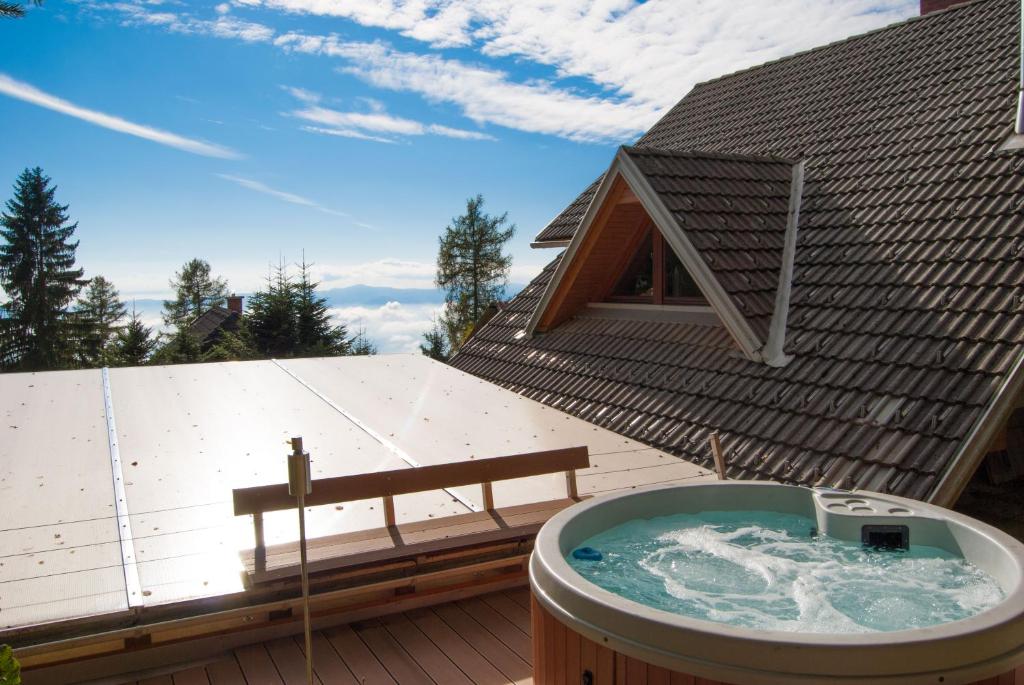a hot tub on the roof of a house at Cottage House Jakob in Cerklje na Gorenjskem