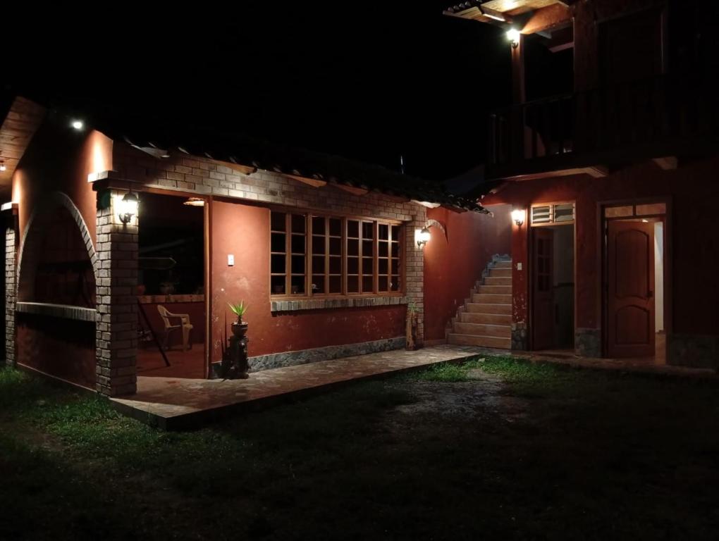 a house lit up at night with a patio at Casa Shaullo-Chalets in Los Baños del Inca