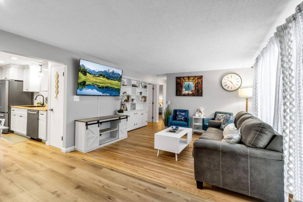 a living room with a couch and a kitchen at New 3BDRM Centrally Located Free Parking AC in Buffalo
