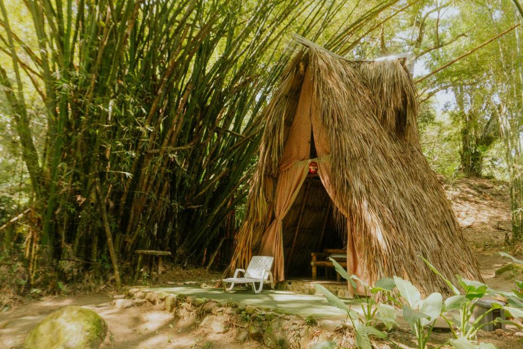 a chair sitting in front of a tree house at Rio Elemento Minca in Santa Marta