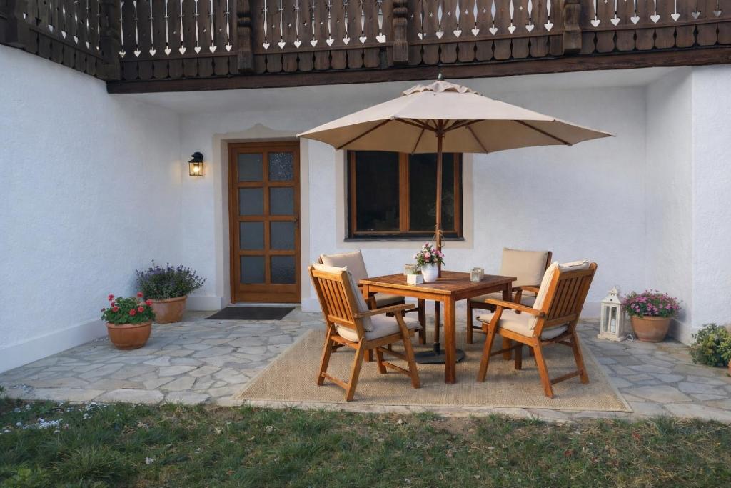a table and chairs with an umbrella on a patio at Ferienhaus 147 in Sekull