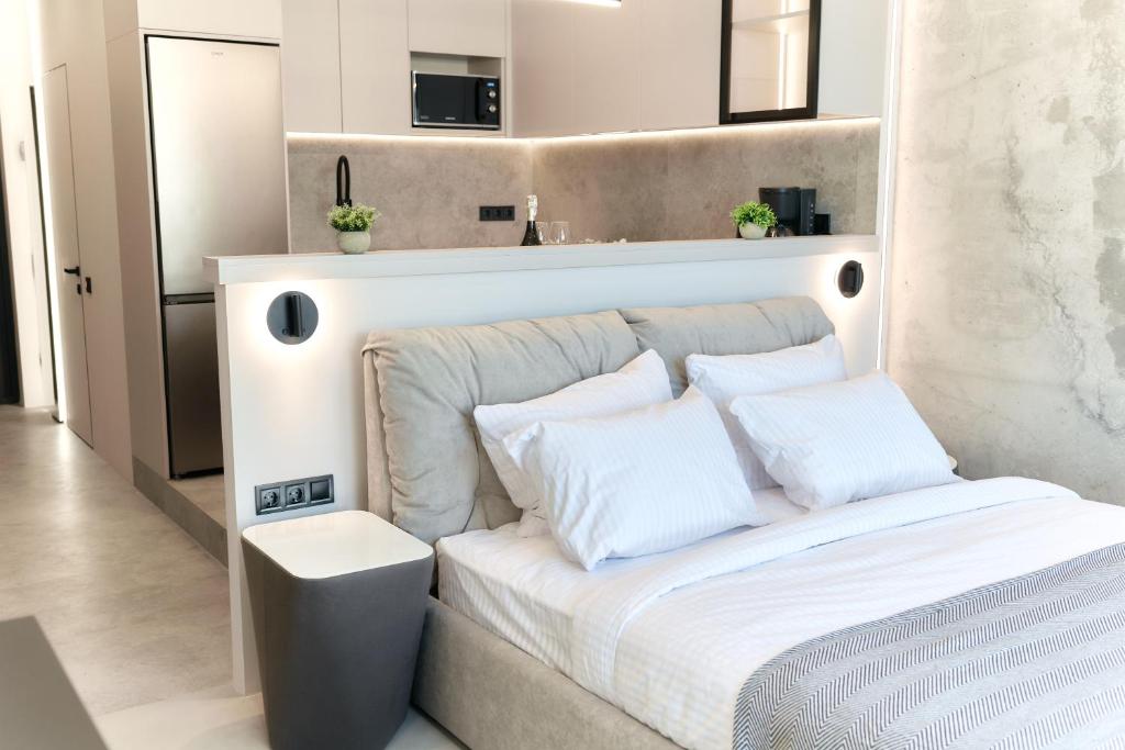 a bedroom with a bed with white sheets and pillows at Designer Studio - Rooftop - Sea View - Arcadia 200m in Odesa