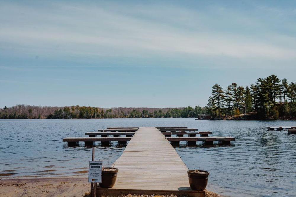 a dock in the middle of a lake at Terrawoods Pine Cottage in Parry Sound