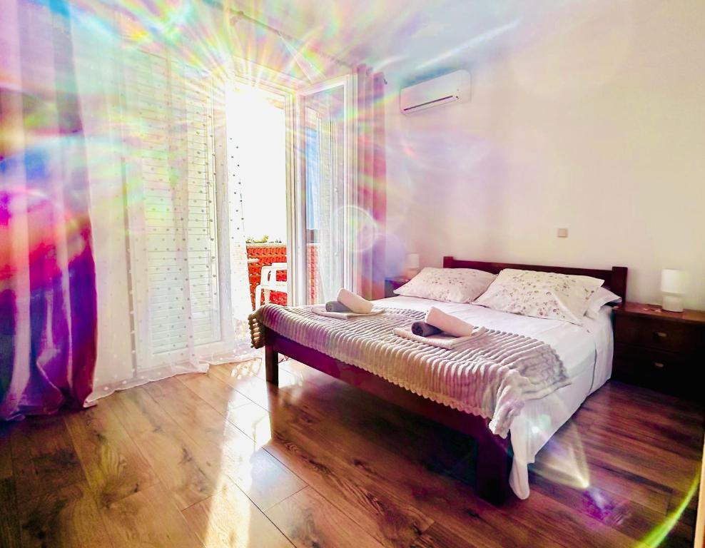 a bedroom with a bed with a rainbowffect at room MLIN 2 in Jakišnica