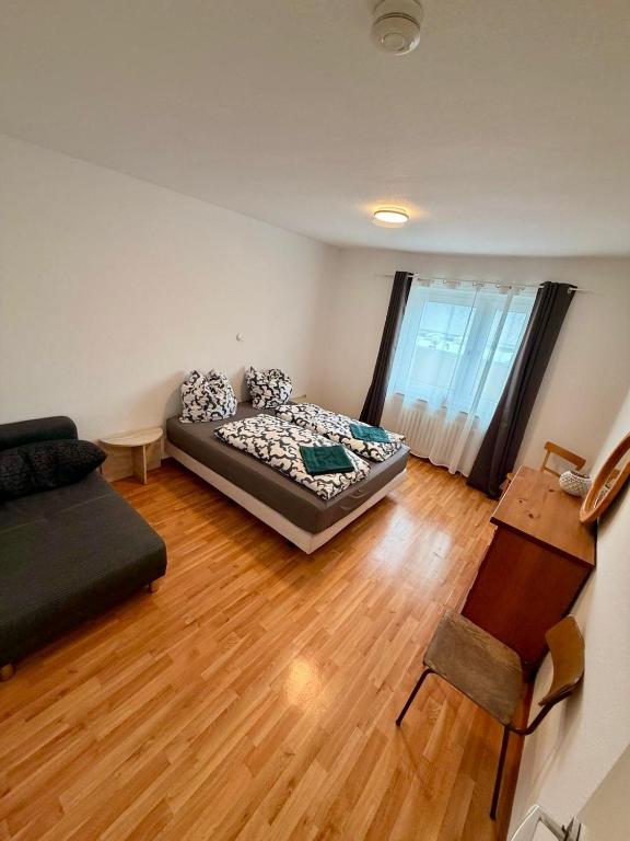 a living room with a bed and a couch at My Apartments&Rooms 04 in Gelsenkirchen