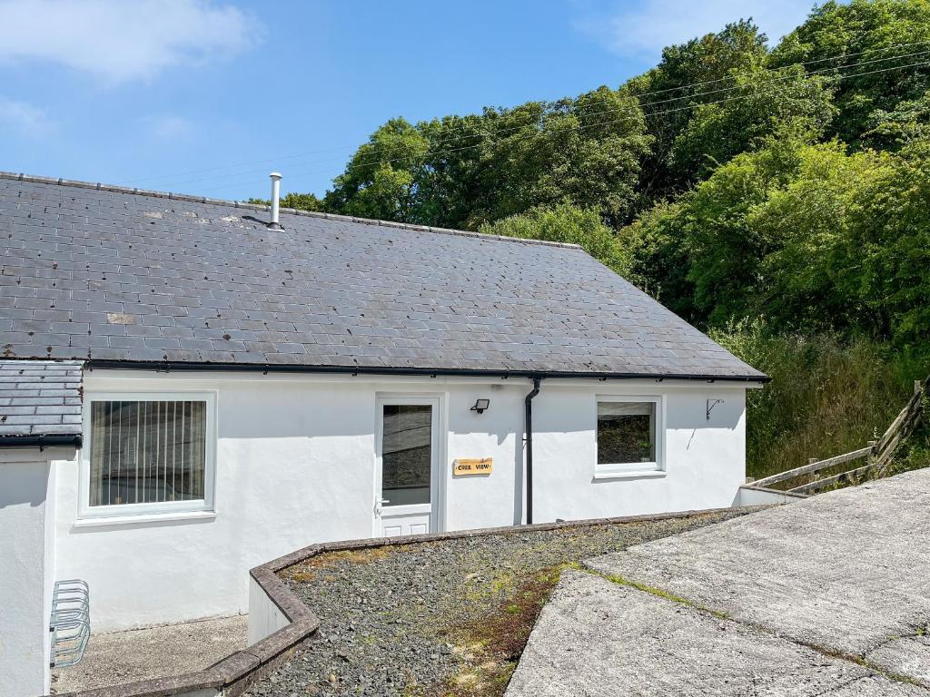 a white house with a gray roof at Uk47551 - Cree View Cottage in Newton Stewart