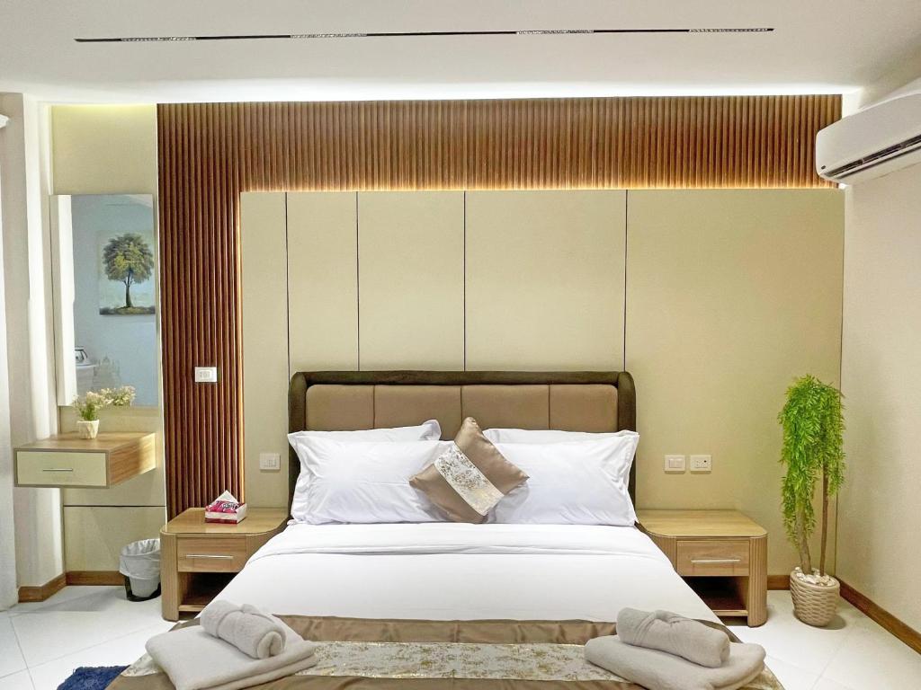 a bedroom with a large bed with two towels on it at Atlantis Hotel in Cairo