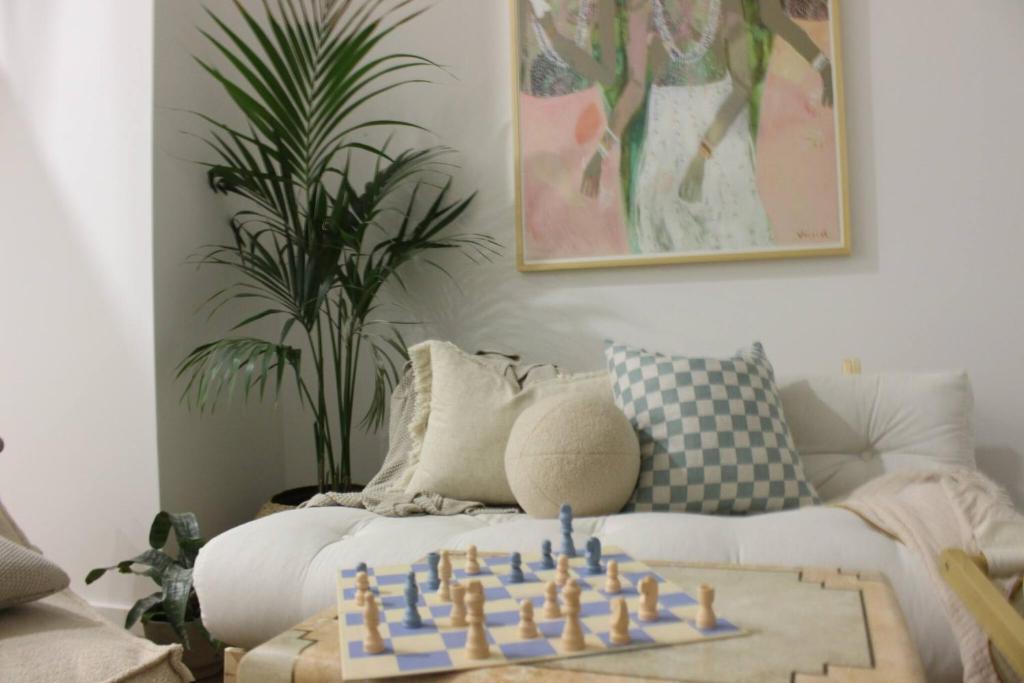 a living room with a chess set on a couch at Bohemian Beach Retreat in Donja Lastva