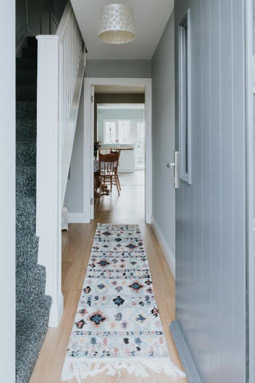 a hallway with a rug on the floor at killarney Townhouse with super location in Killarney
