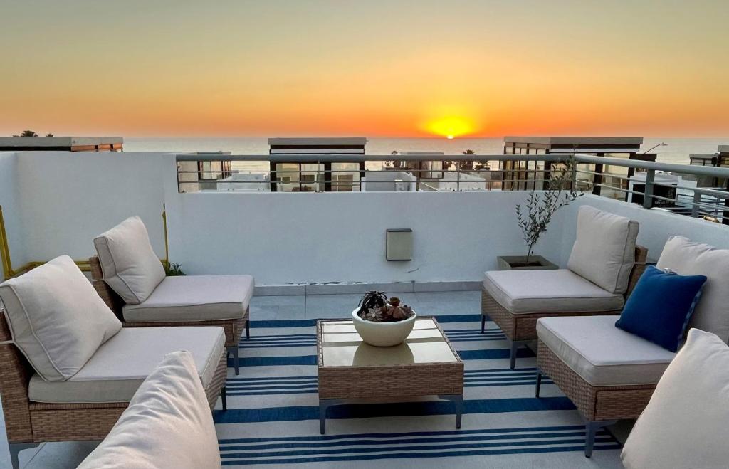 a balcony with chairs and a table on a ship at Baja Ocean View 3 BR Panoramic Terrace & Private Jacuzzi 8pp in Rosarito