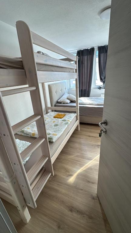 a room with two bunk beds and a door at Bay Fewo in Rosenheim