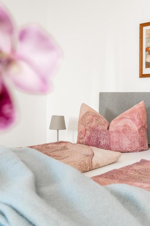 a bedroom with two beds and a table with a lamp at Pension Kohlweg - Free Parking, Garden and air conditioning in Graz