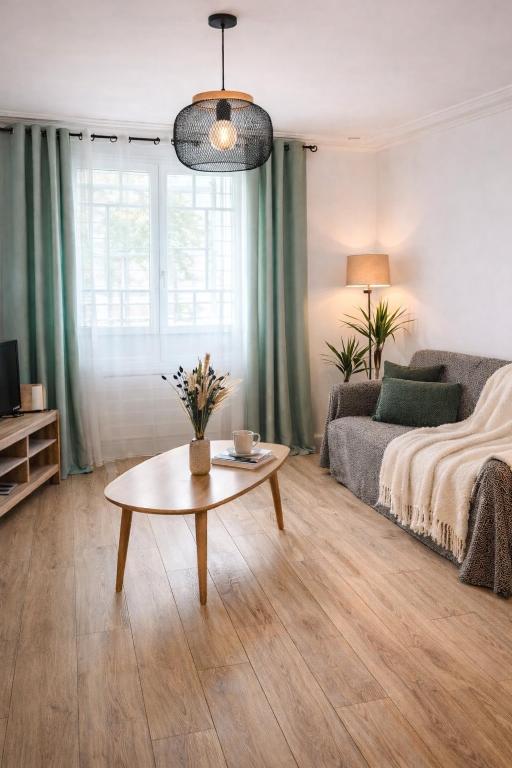 a living room with a bed and a coffee table at L'Opale in Wimereux