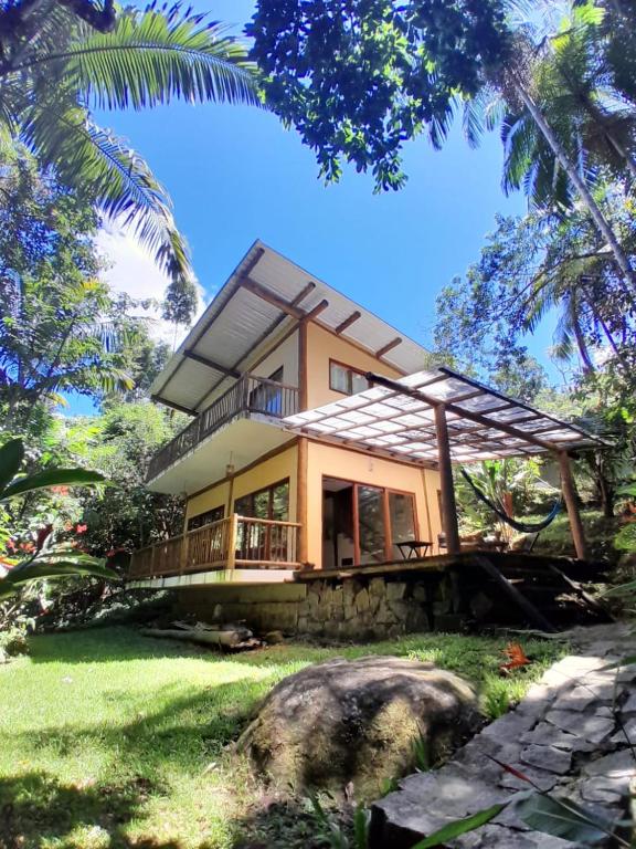 a house with a roof on top of a yard at Casa da Ponte, Trindade in Trindade