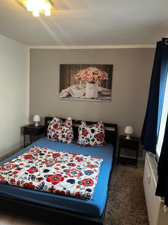 a bedroom with a bed and a vase of flowers at Hinterhaus-Idyll Markranstädt in Markranstädt