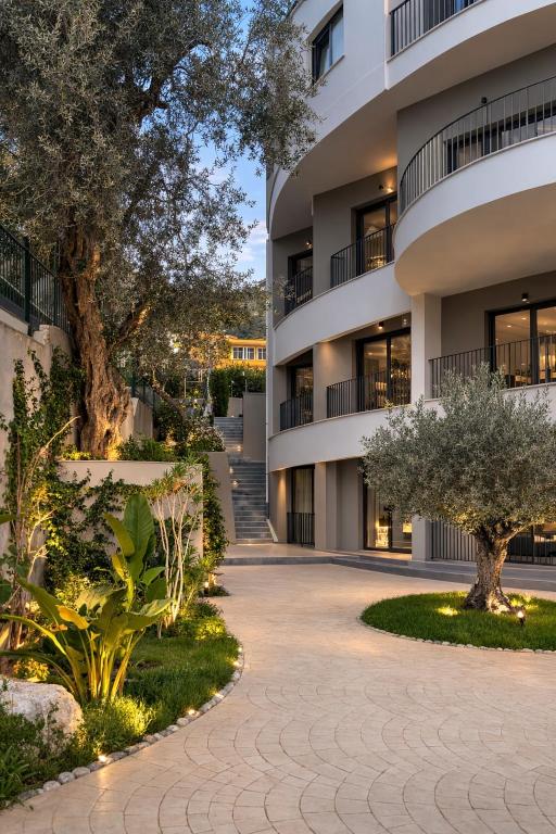 an apartment building with trees in front of it at Dior Apartment in Vlorë