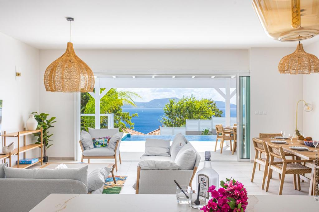 a living room with a view of the ocean at Villa Andrea in Case-Pilote