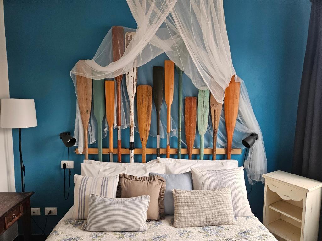 a bedroom with a bed with surfboards on the wall at VILLA VILLACOLLE in Procchio