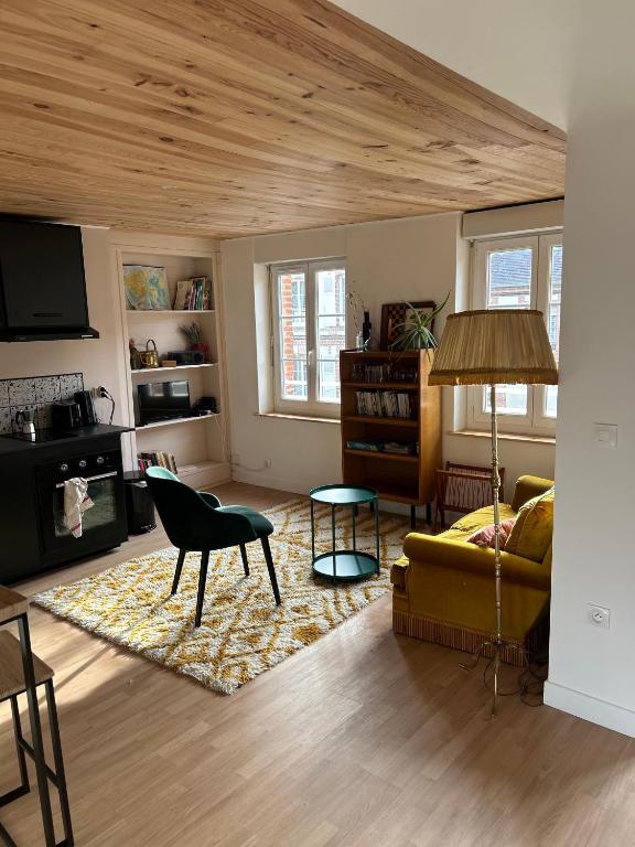 a living room with a couch and a table at Appartements Lambotte in LʼAigle