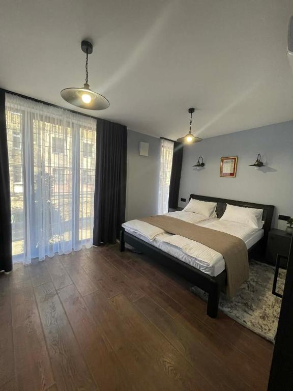 a bedroom with a bed and a large window at Villa Rinat Boutigue Hotel in Kyiv