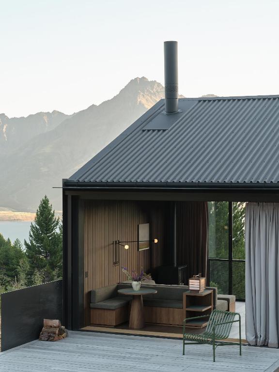 a house with a couch and a table on a patio at Moke Valley Queenstown in Queenstown