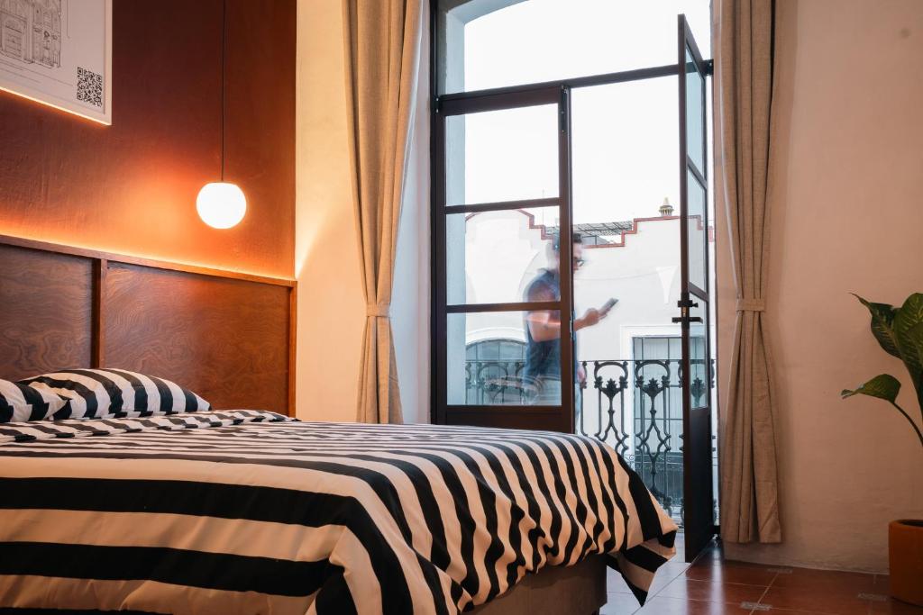 a zebra print bed in a room with a window at Casa Serdán in Puebla