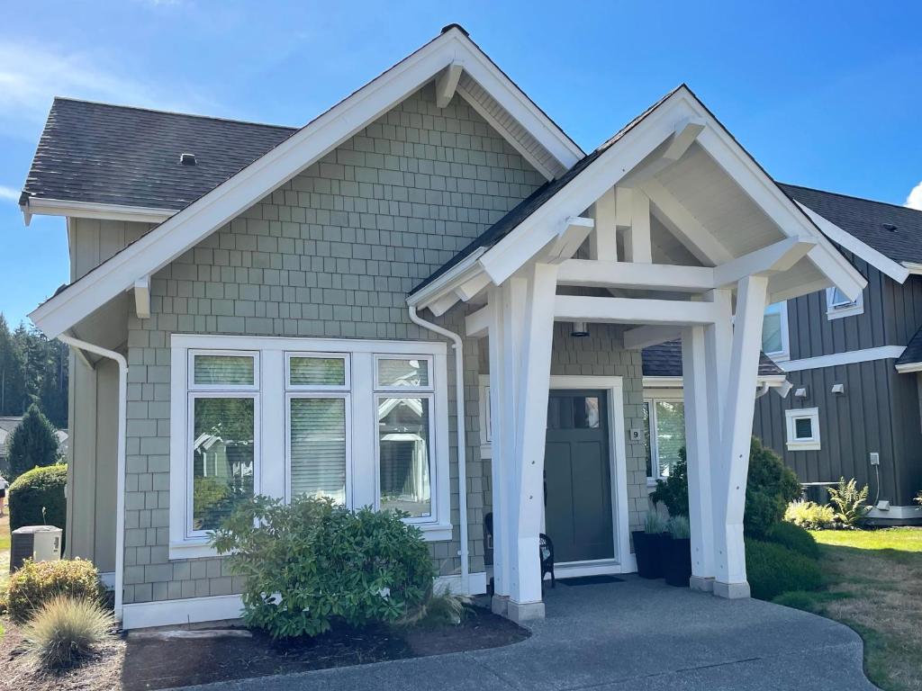 a house with a front door and a porch at Qualicum Landing Beachside Home in Qualicum Beach