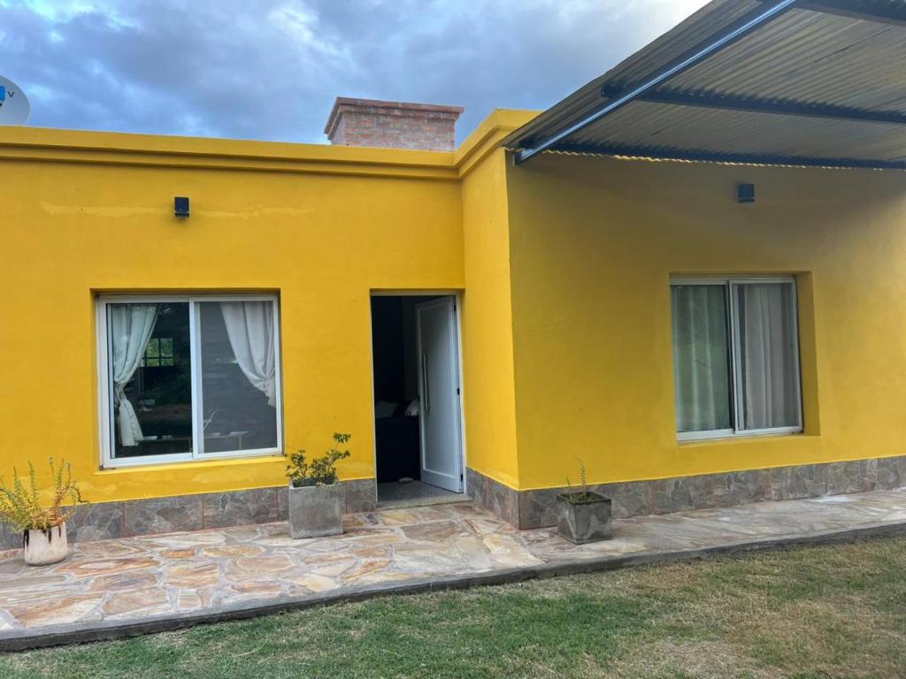 a yellow house with a door and windows at Casa en La Puntilla in Belén