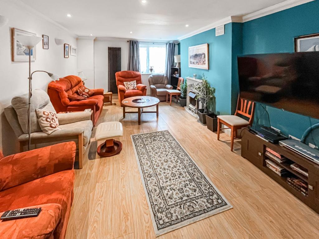 a living room with a couch and a flat screen tv at Turner Villa in Ramsgate