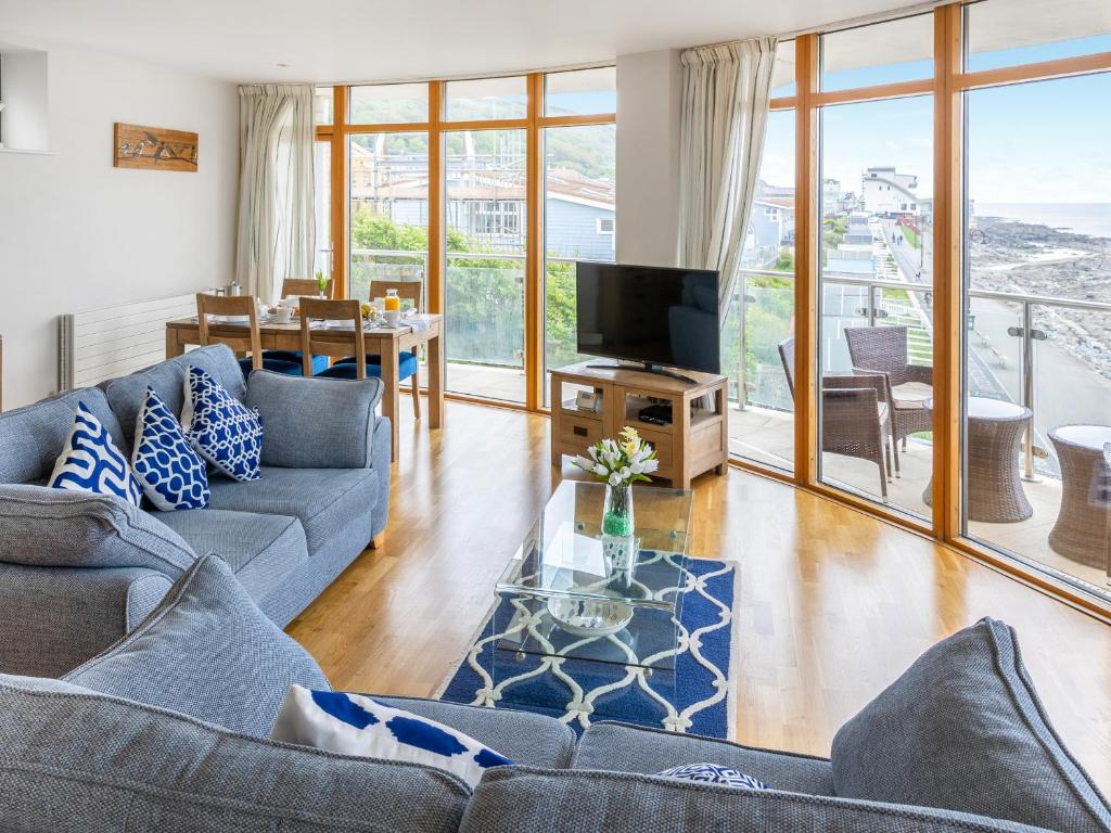 a living room with a couch and a television at Apartment 22, Horizon View in Westward Ho