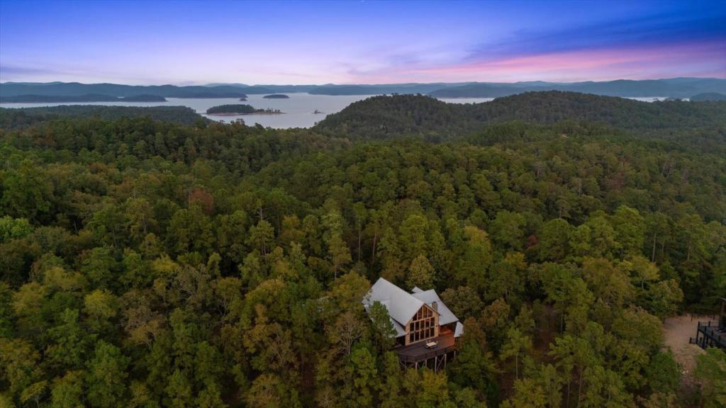 an aerial view of a house in the woods at New Unbelievable Views Gourmet Kitchen Firepit in Broken Bow