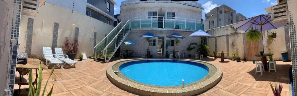 a large swimming pool in front of a building at Pousada Camboinha in Cabedelo