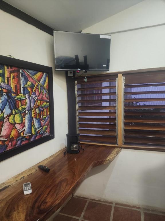 a living room with a wooden floor and a flat screen tv at tatay cabinas in La Cruz