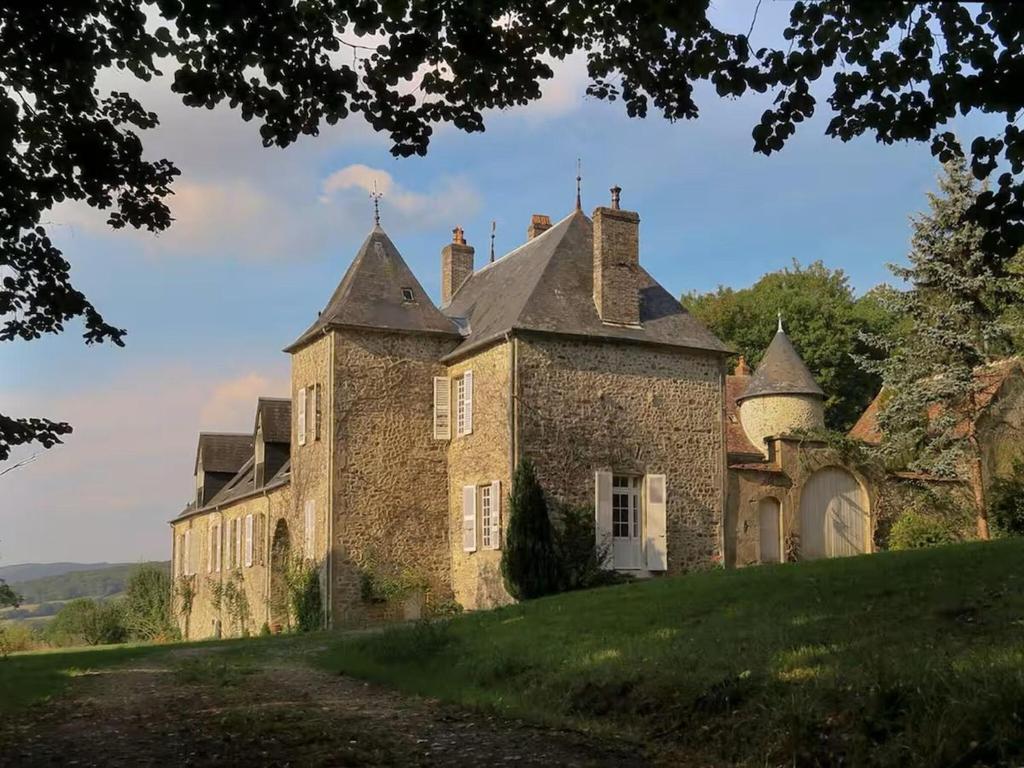 an old stone building on a grassy hill at Cosy Castle with Pool in Onlay in Onlay