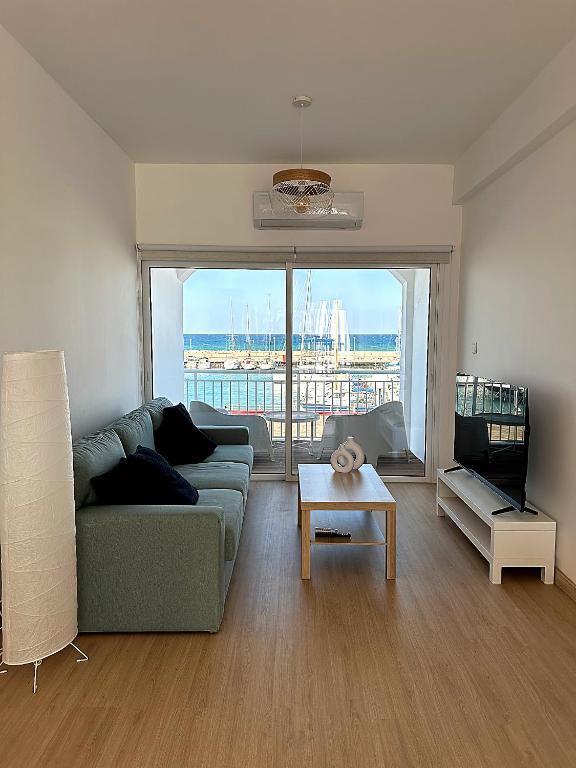 a living room with a couch and a table at Harbour No4 in Polis Chrysochous