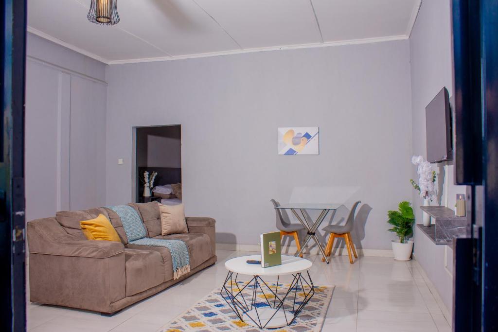 a living room with a couch and a table at The Views Apartments in Kariba