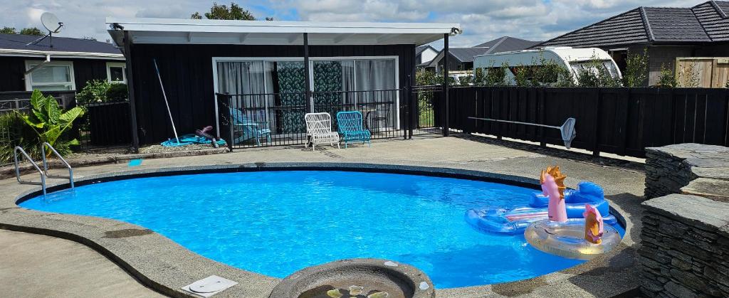 a small swimming pool with two people in it at The Poolhouse in Matamata