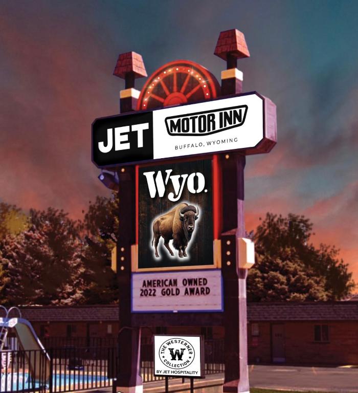 a sign for a wyo sign with a dog on it at JET Motor Inn - Buffalo in Buffalo