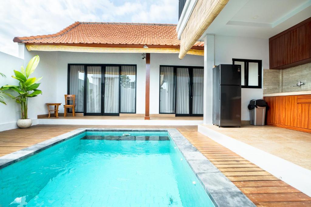 a villa with a swimming pool and a house at 2BR Rice Field View Private Villa in Cemagi in Canggu