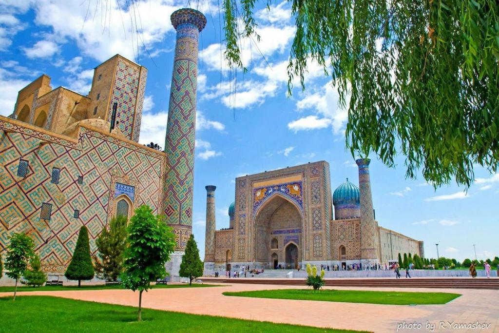 a building with two towers and a courtyard at Anora home in Samarkand