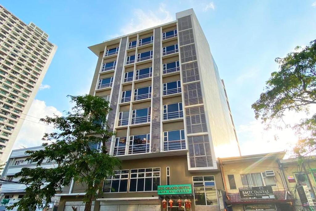 a tall building with windows on the side of it at LTG Grand Hotel Cebu in Cebu City